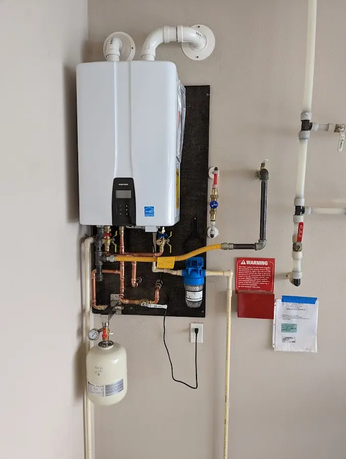 Professional plumber installing copper piping in a Albany home